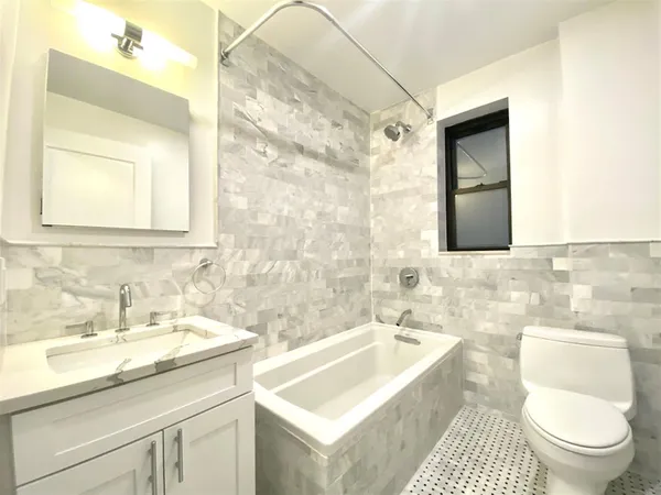 a bathroom with a sink a toilet and a mirror