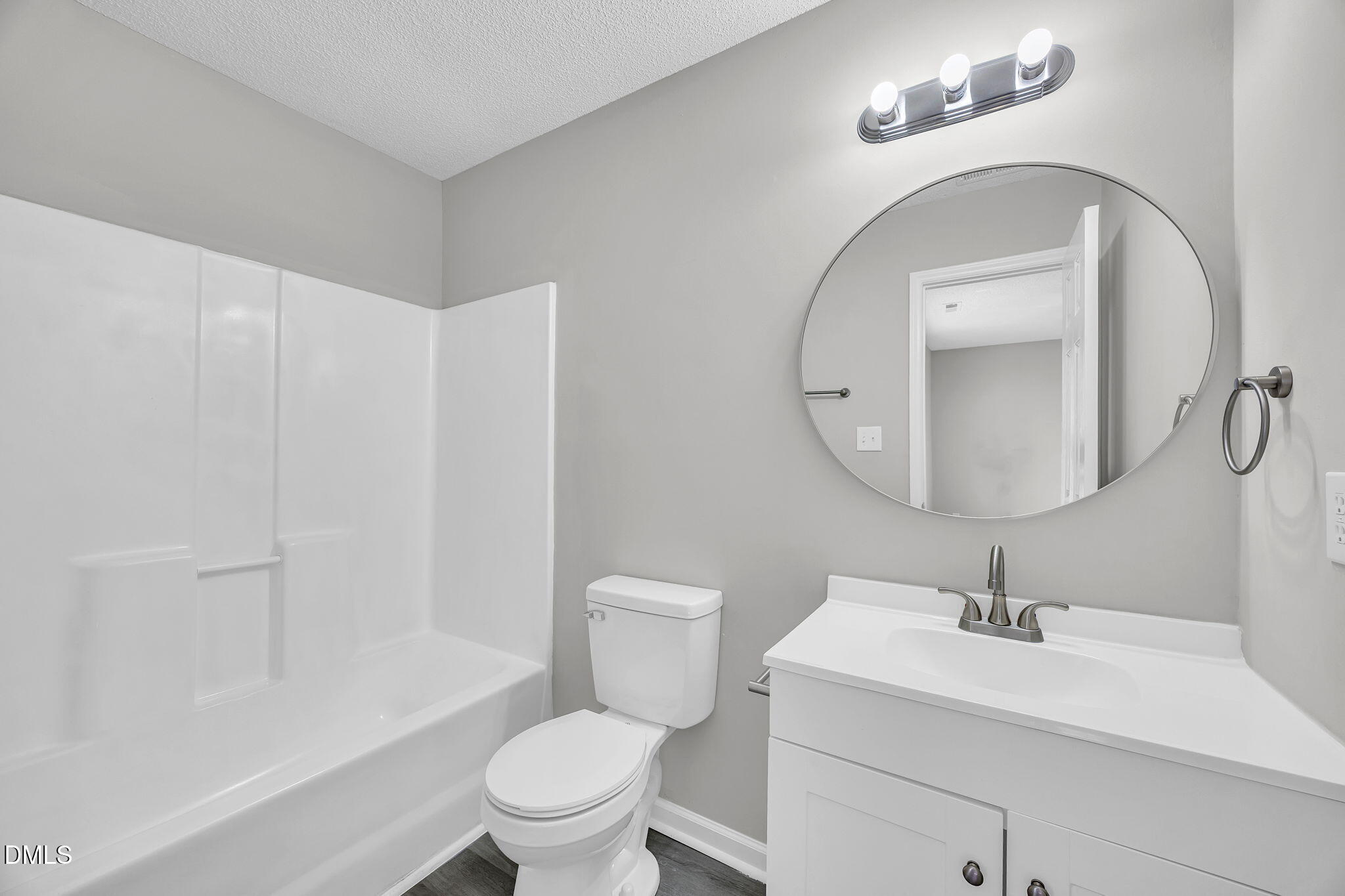 2231 Violet Bluff Court Raleigh, NC 27610 - Photo 13 of 16 a bathroom with a sink a toilet and a mirror