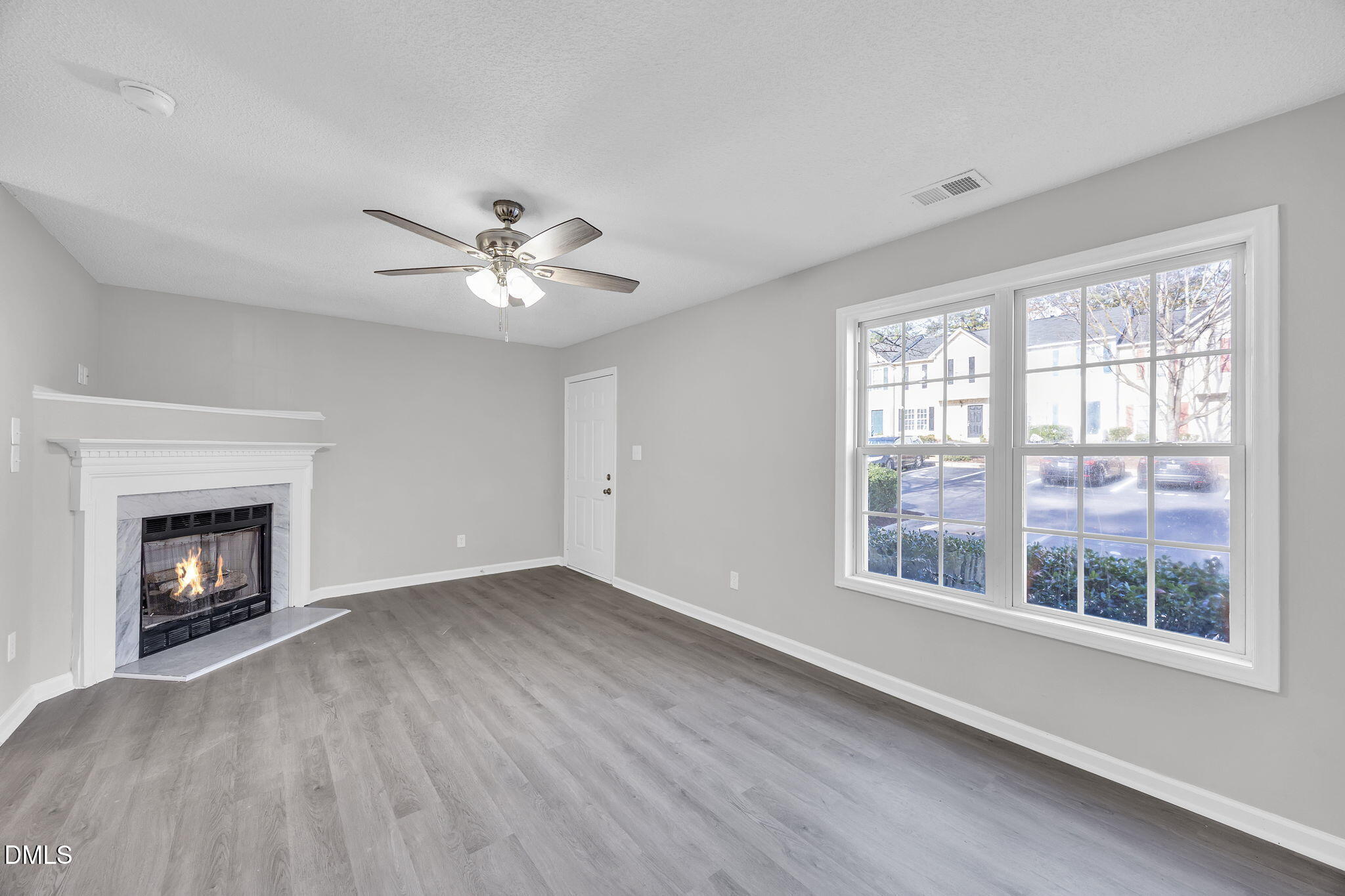 2231 Violet Bluff Court Raleigh, NC 27610 - Photo 4 of 16 a view of an empty room with a fireplace and a window