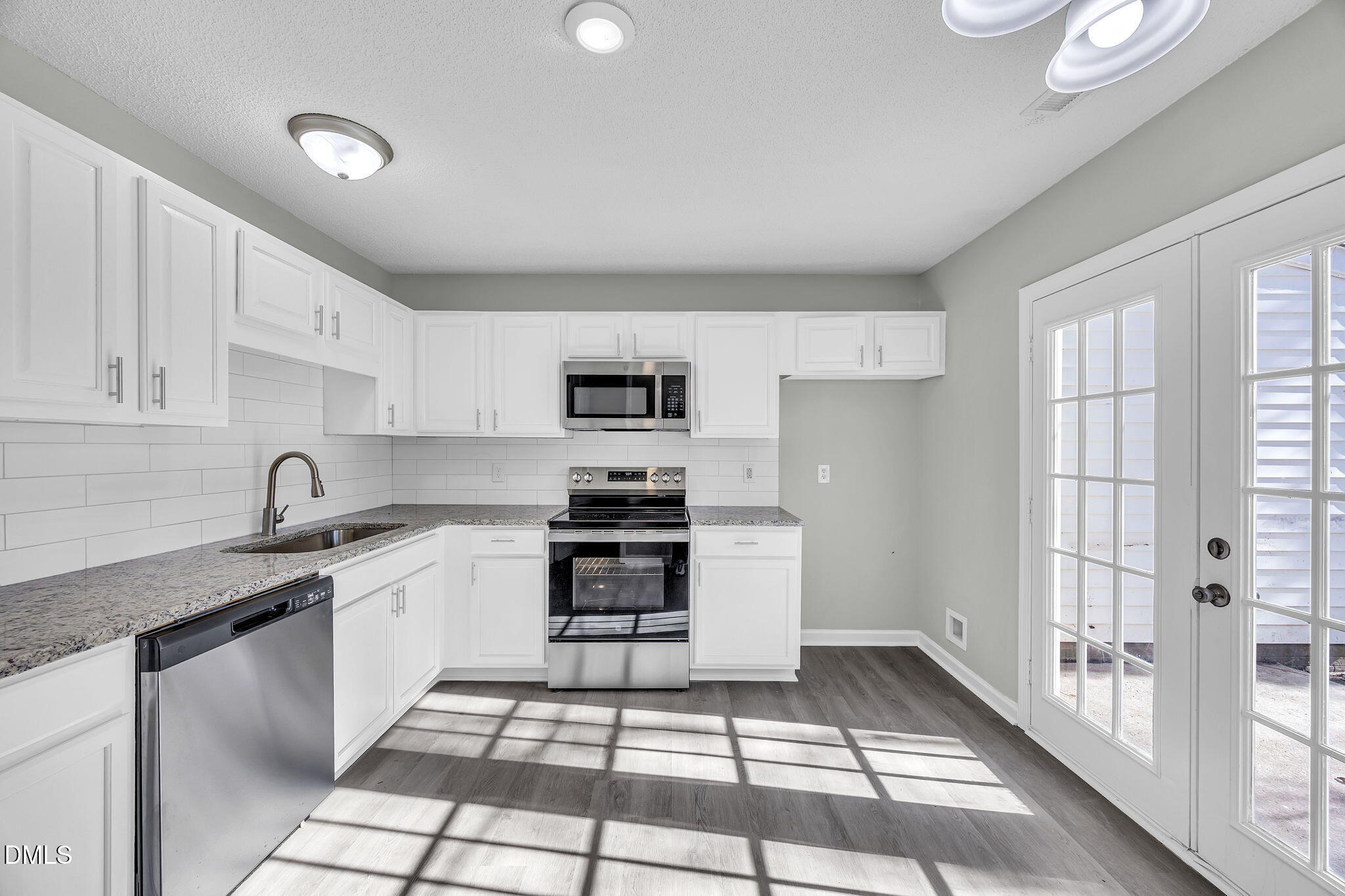 2231 Violet Bluff Court Raleigh, NC 27610 - Photo 5 of 16 a kitchen with stainless steel appliances granite countertop a stove a sink and a refrigerator