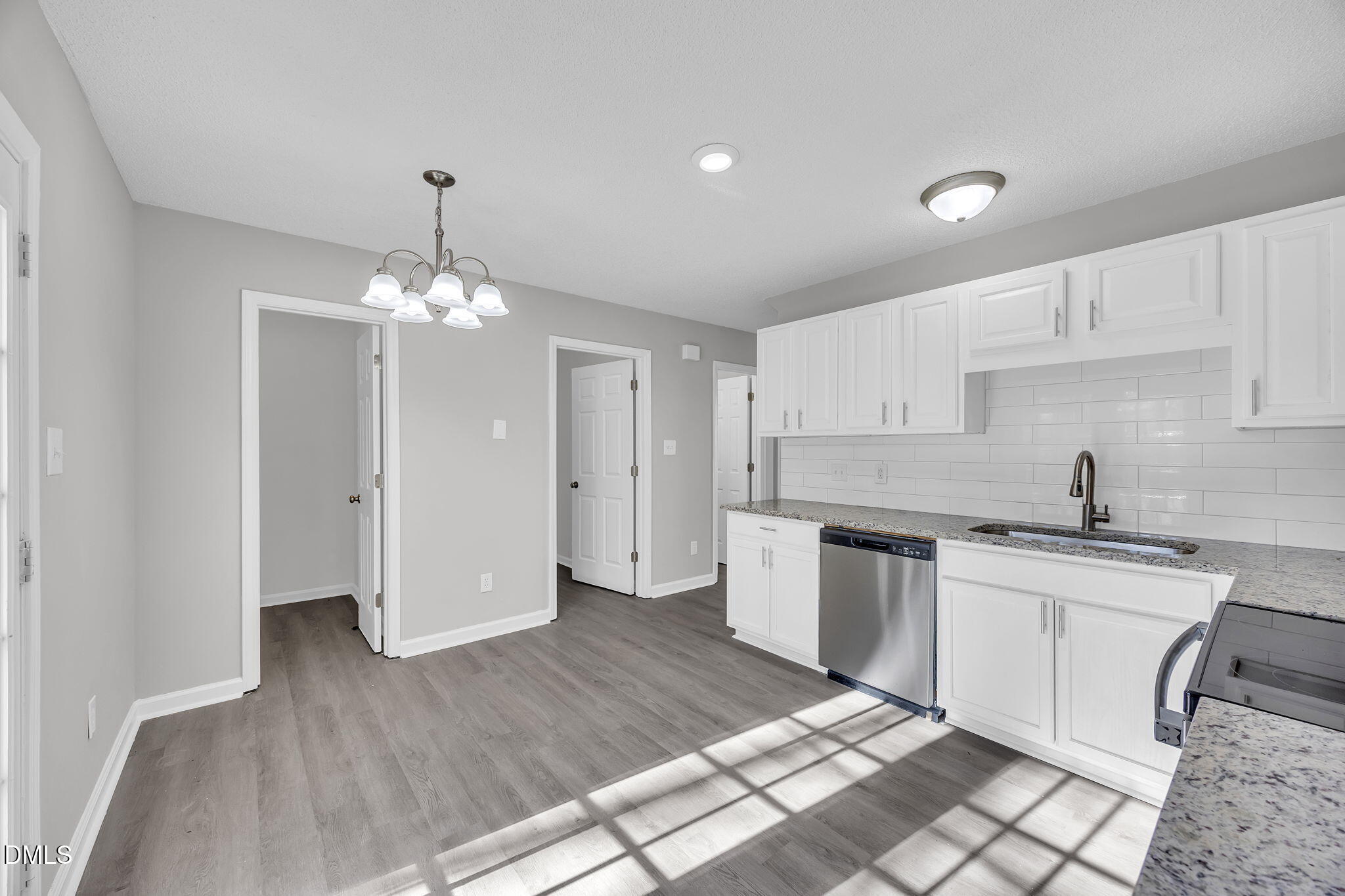 2231 Violet Bluff Court Raleigh, NC 27610 - Photo 6 of 16 a kitchen with stainless steel appliances granite countertop a sink stove and refrigerator