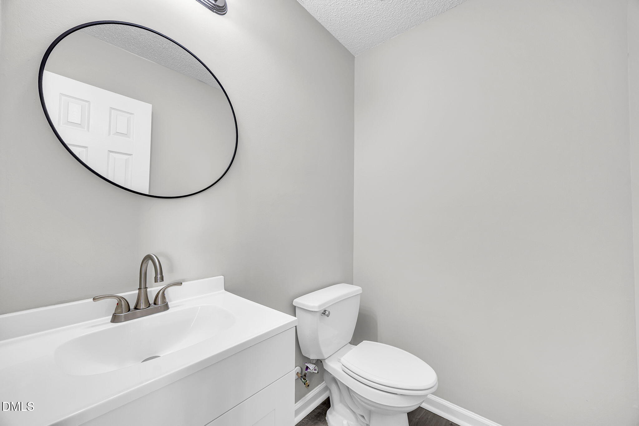 2231 Violet Bluff Court Raleigh, NC 27610 - Photo 8 of 16 a bathroom with a sink and a mirror