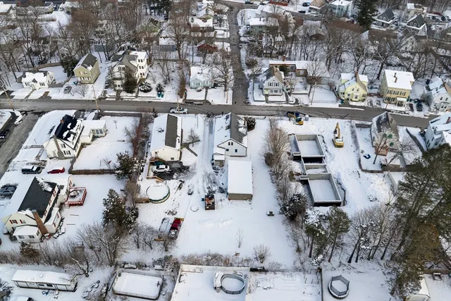 an aerial view of a house with outdoor seating