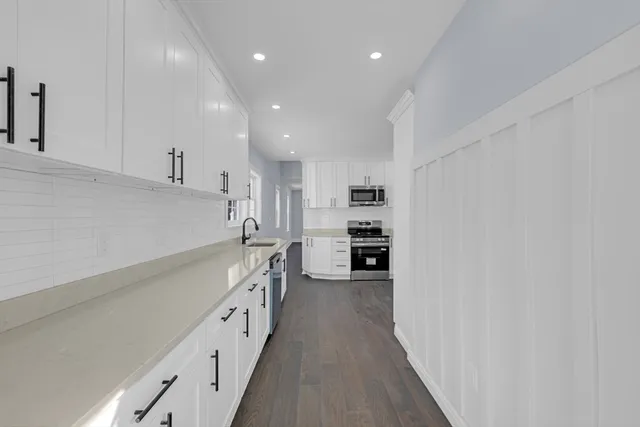 a kitchen with cabinets and a stove