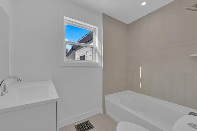 a bathroom with a bathtub and toilet