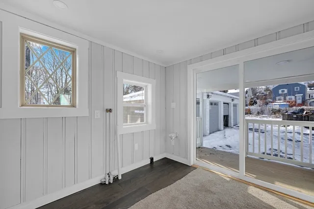 a view of a livingroom with wooden floor and windows
