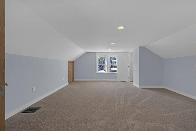 a view of a big room with windows and chandelier