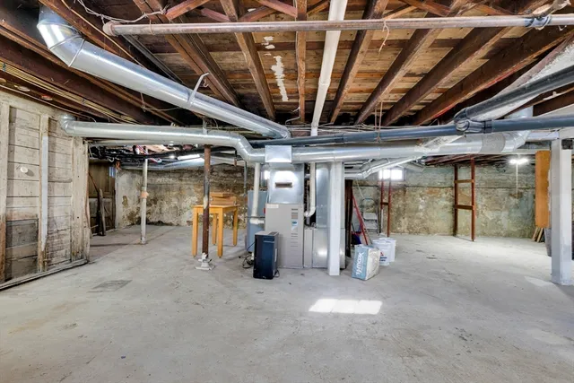 a view of water heater room with refrigerator