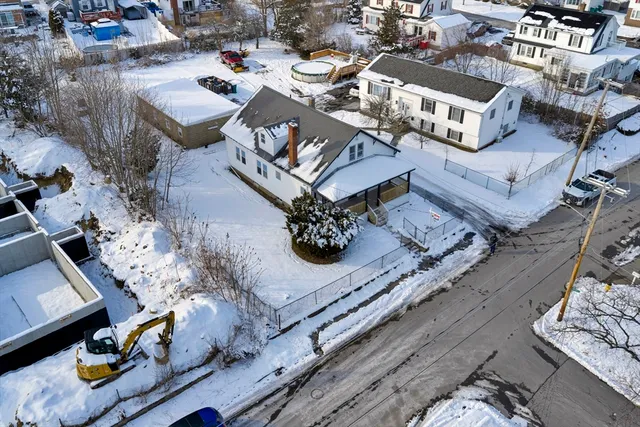 an aerial view of a houses with street