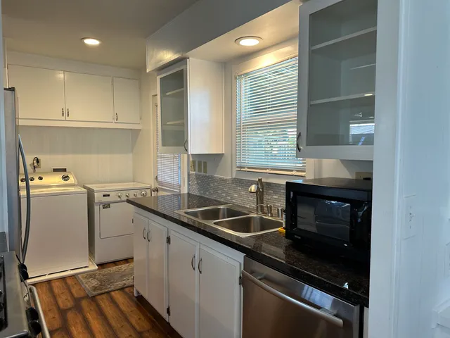 a kitchen that has a sink and a stove