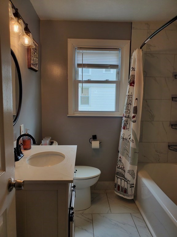 21 Nathaniel Street Springfield, MA 01109 - Photo 6 of 20 a bathroom with a sink a toilet and bathtub