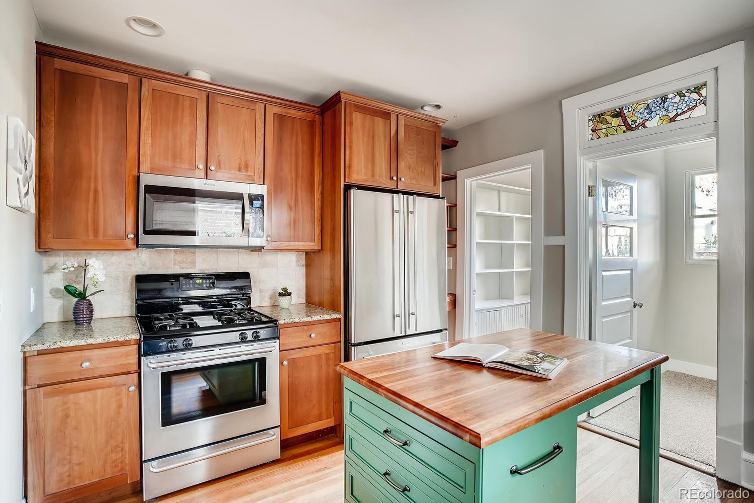 1028 Cook Street Denver, CO 80206 - Photo 11 of 40 a kitchen with a stove and a microwave