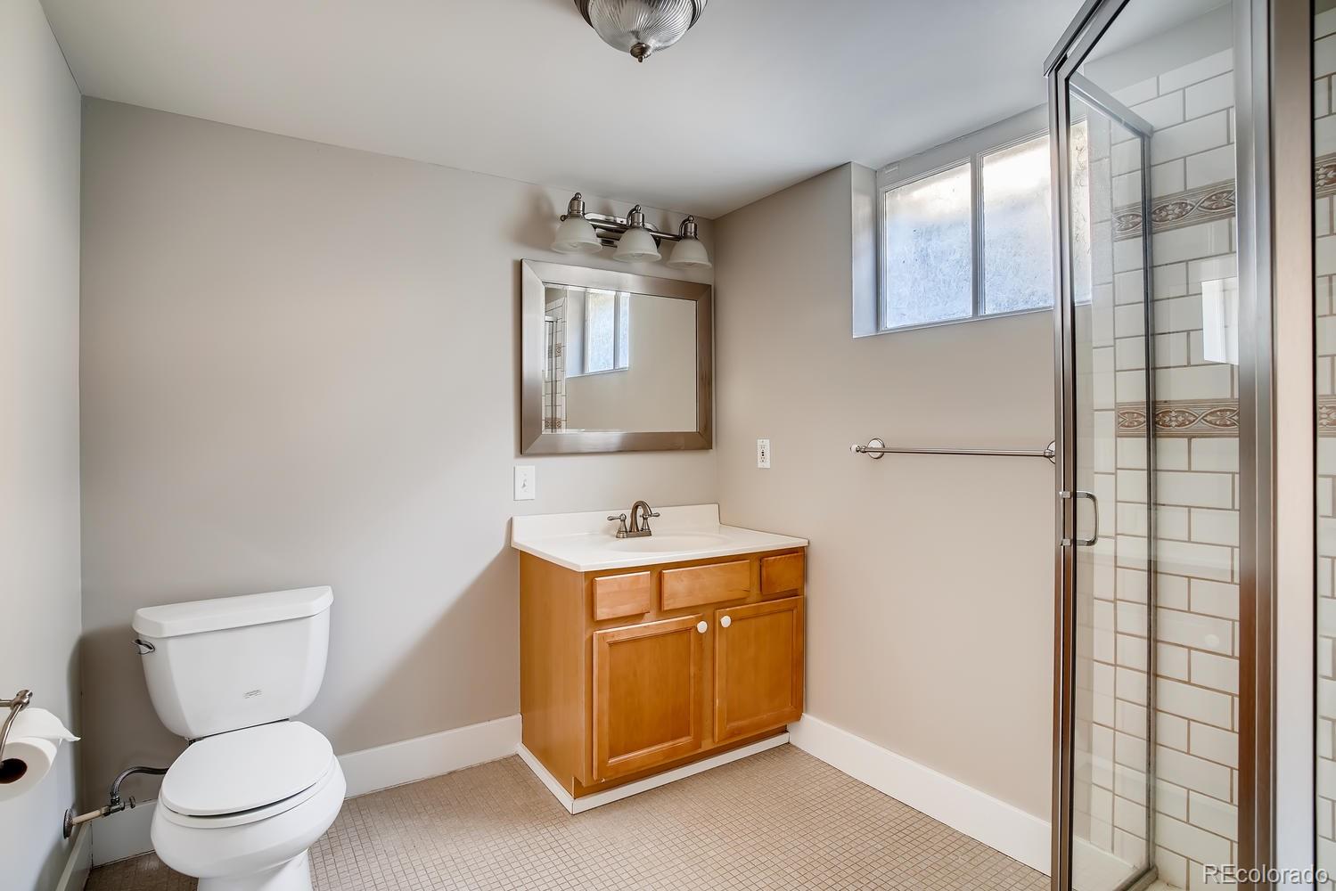 1028 Cook Street Denver, CO 80206 - Photo 15 of 40 a bathroom with a toilet sink and mirror