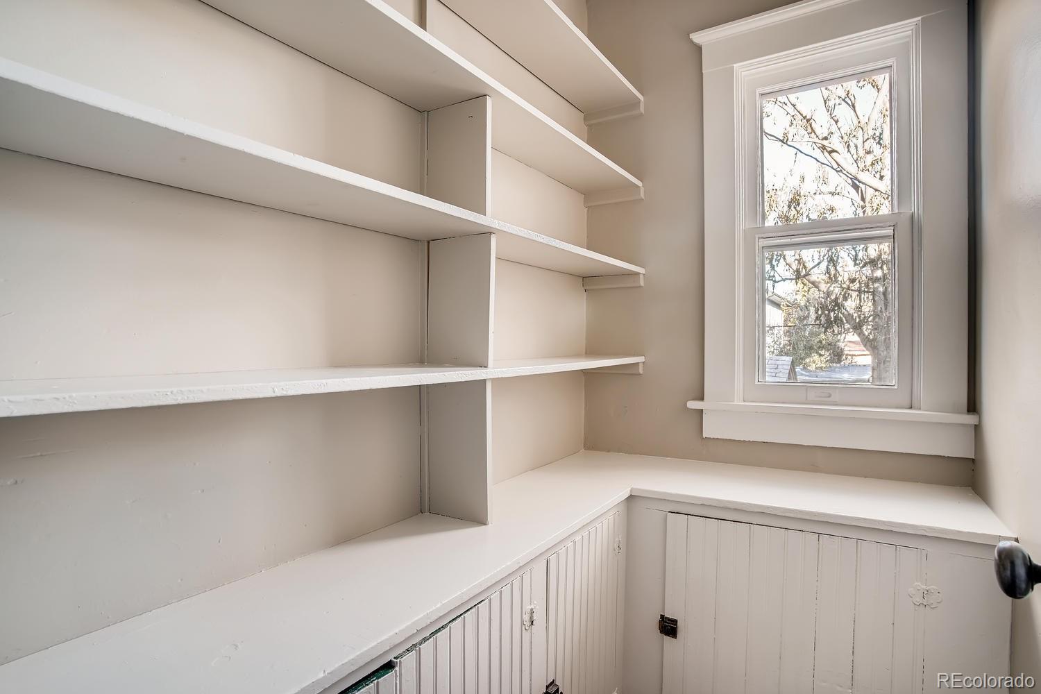 1028 Cook Street Denver, CO 80206 - Photo 16 of 40 a hallway with cabinets and a window