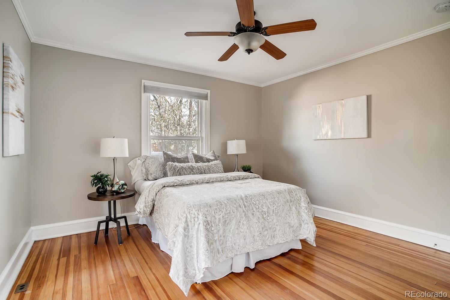 1028 Cook Street Denver, CO 80206 - Photo 19 of 40 a bedroom with a bed and wooden floor