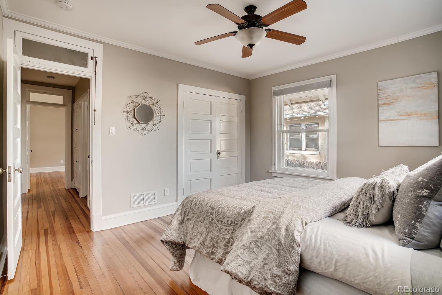 1028 Cook Street Denver, CO 80206 - Photo 22 of 40 a bedroom with a large bed and a window