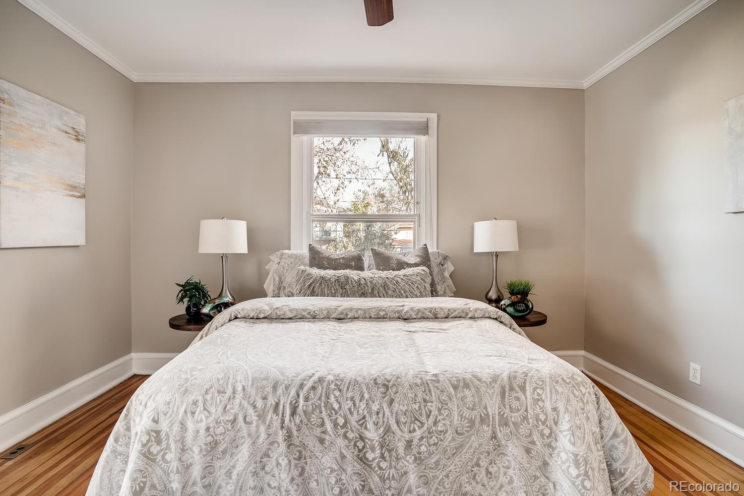 1028 Cook Street Denver, CO 80206 - Photo 23 of 40 a bedroom with a bed and a window