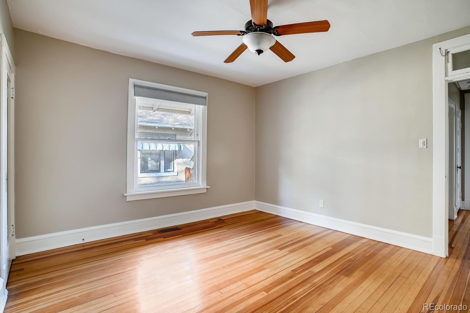 1028 Cook Street Denver, CO 80206 - Photo 25 of 40 a view of empty room with wooden floor and fan