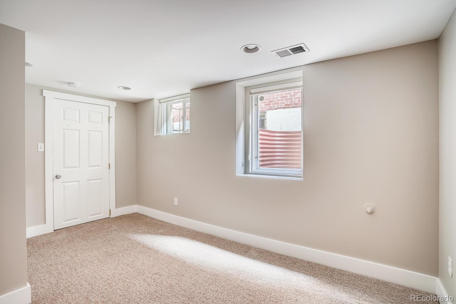 1028 Cook Street Denver, CO 80206 - Photo 28 of 40 a view of an empty room with a window