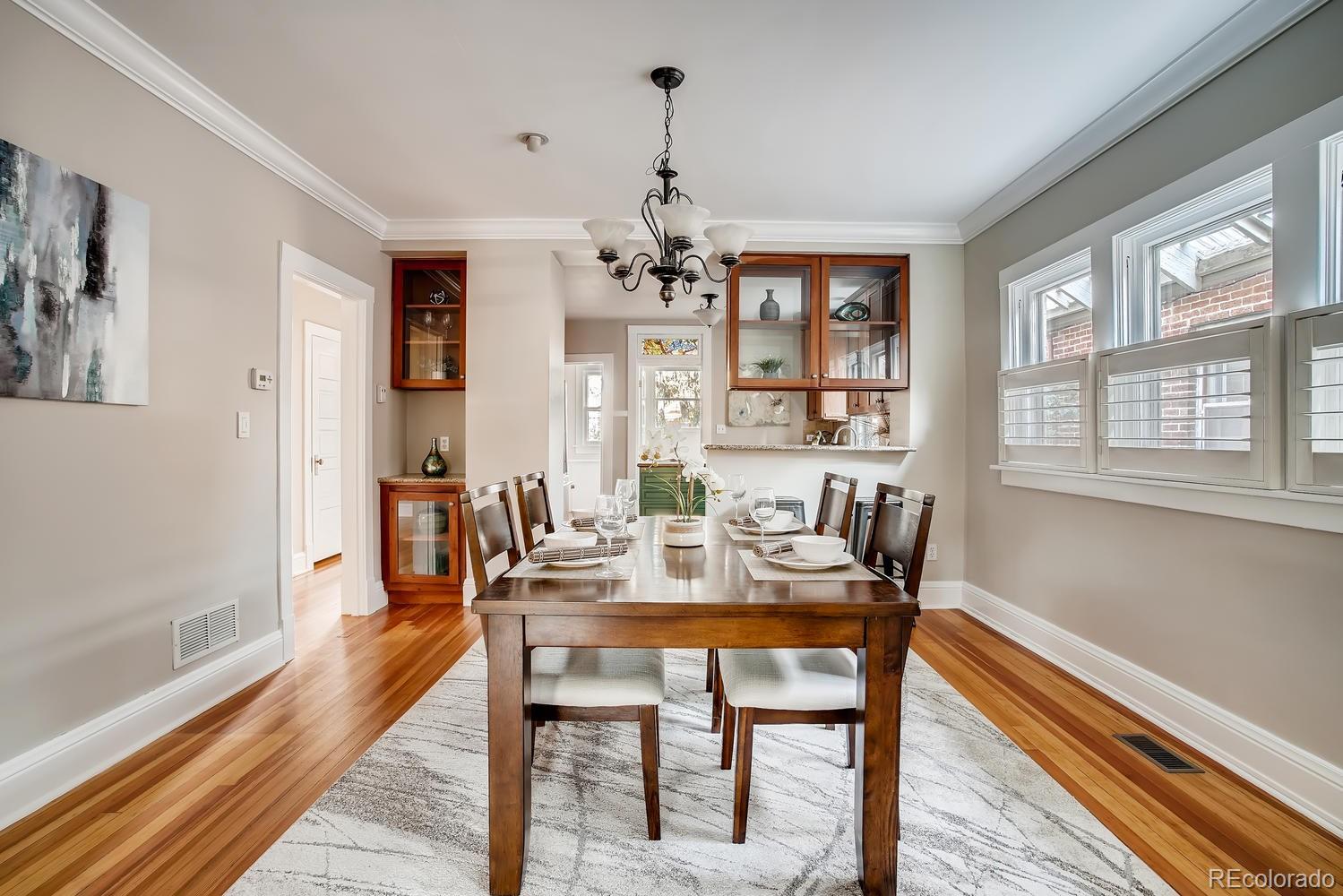 1028 Cook Street Denver, CO 80206 - Photo 7 of 40 a view of a dining room with furniture window and wooden floor