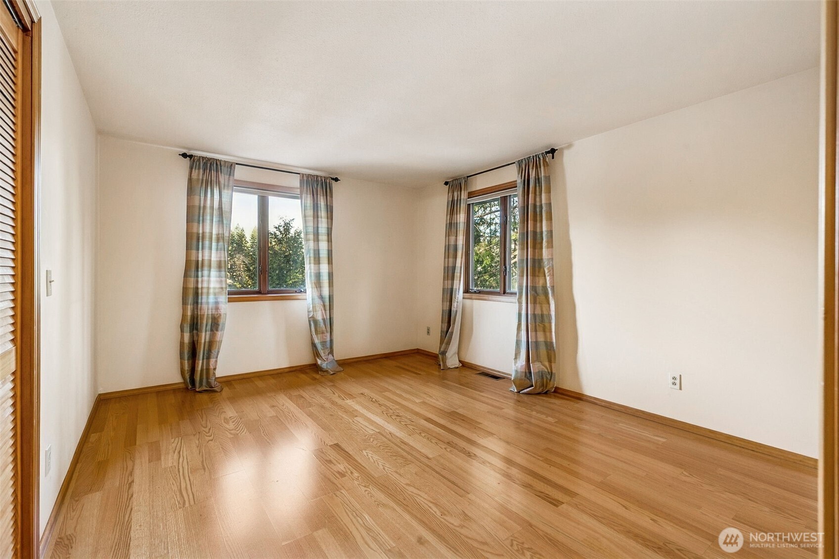 5221 Blvd Ext Road Southeast Olympia, WA 98501 - Photo 17 of 25 an empty room with wooden floor and windows