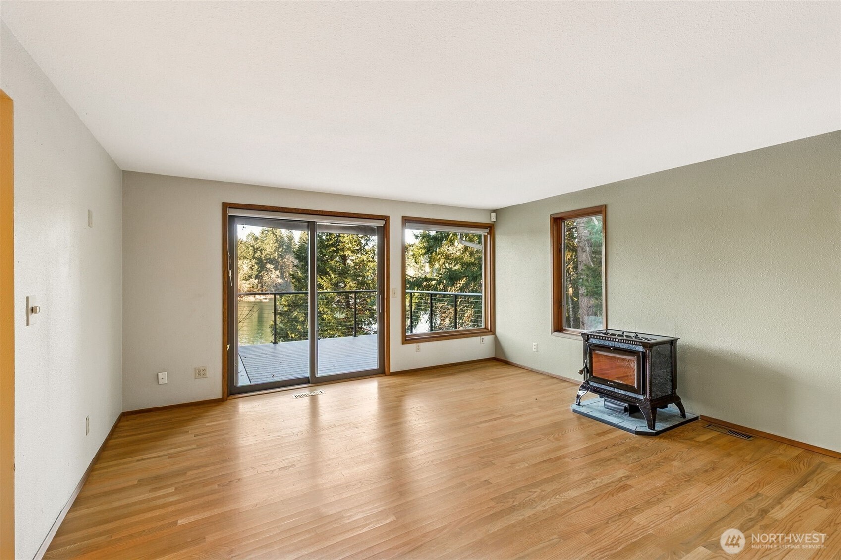 5221 Blvd Ext Road Southeast Olympia, WA 98501 - Photo 2 of 25 a view of an empty room with wooden floor and a window