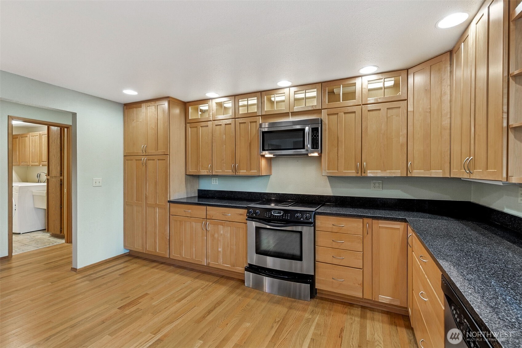 5221 Blvd Ext Road Southeast Olympia, WA 98501 - Photo 5 of 25 a kitchen with stainless steel appliances granite countertop a sink and wooden cabinets