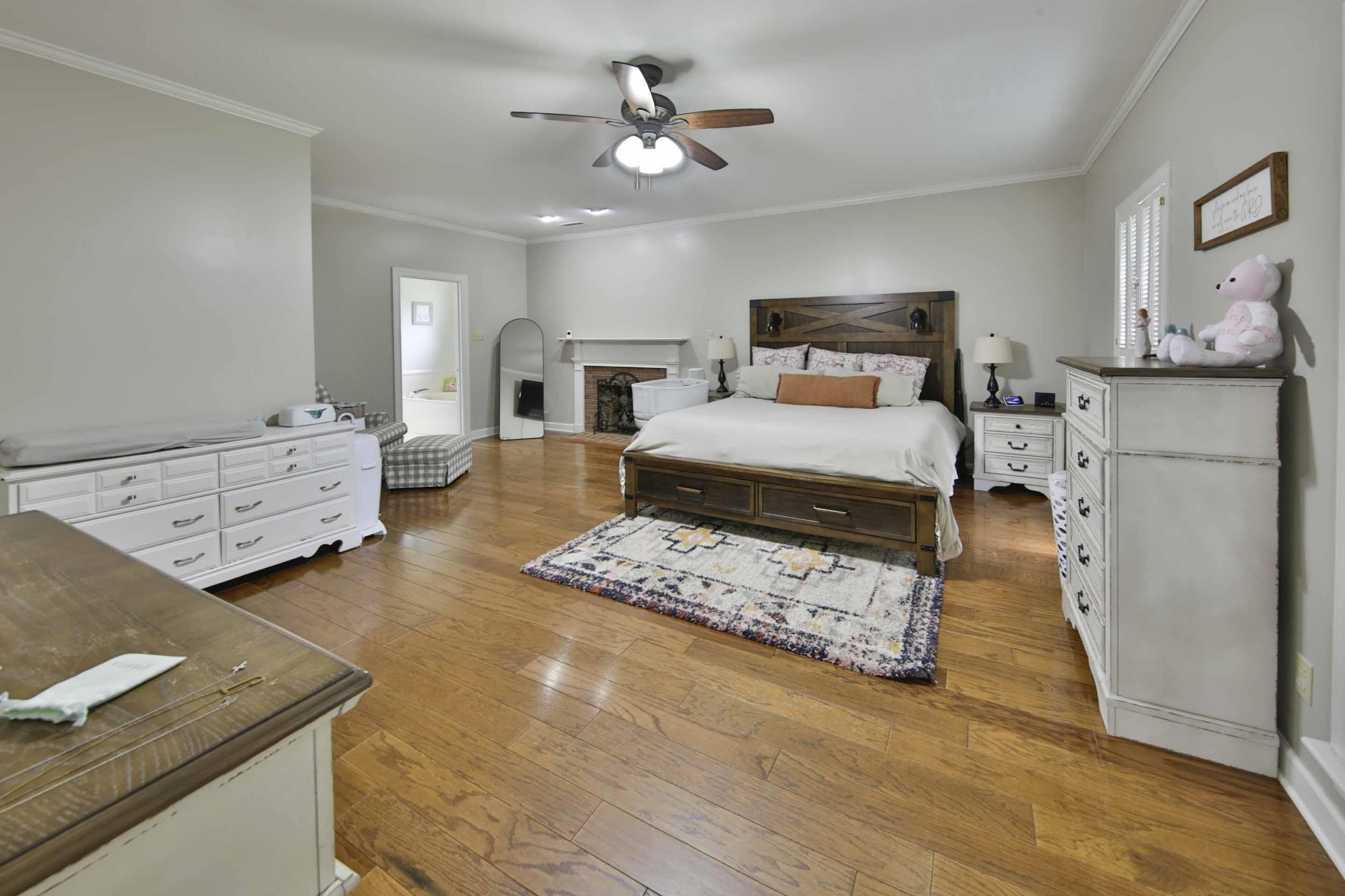 104 Miller Road Covington, TN 38019 - Photo 18 of 25 Spacious room featuring wood-finish flooring, a ceiling fan, and crown molding