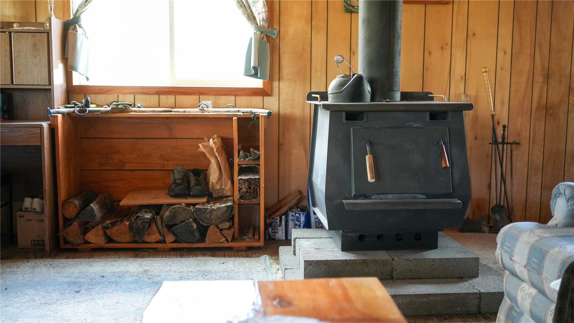 240 Old Railroad Road Oroville, WA 98844 - Photo 14 of 24 a living room with furniture a window and a fireplace