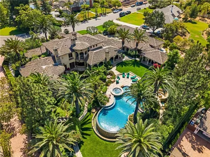 an aerial view of a house with a swimming pool yard and outdoor seating
