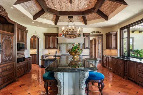 a kitchen with granite countertop cabinets stove and microwave