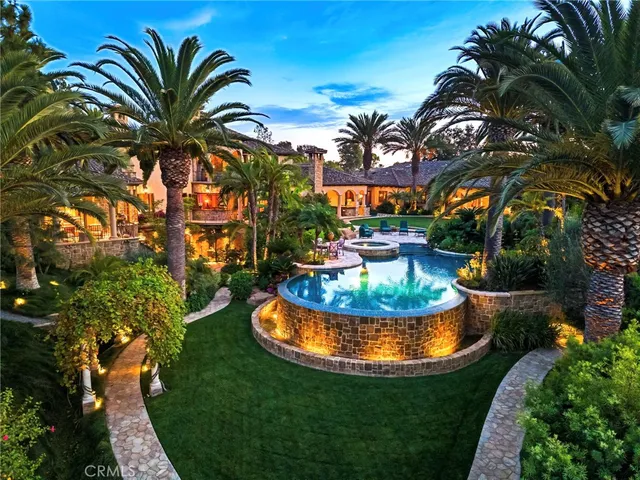 an aerial view of a house with a swimming pool yard and outdoor seating