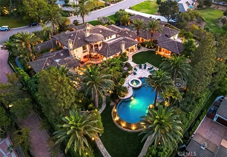 a living room with fireplace furniture and a chandelier