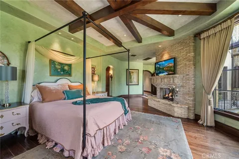 a bedroom with a bed and a large window