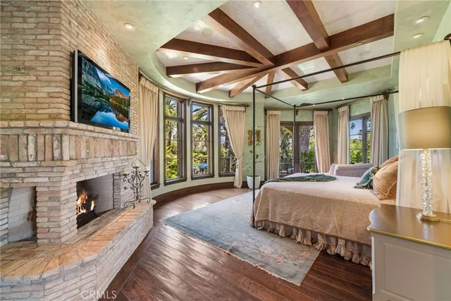 a bedroom with a bed and a large window