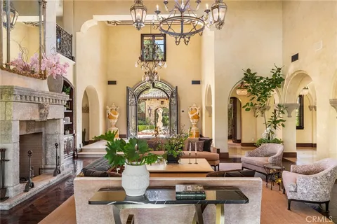a living room with furniture a fireplace and a large window