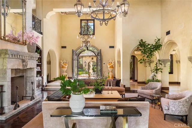 a living room with furniture a fireplace and a large window