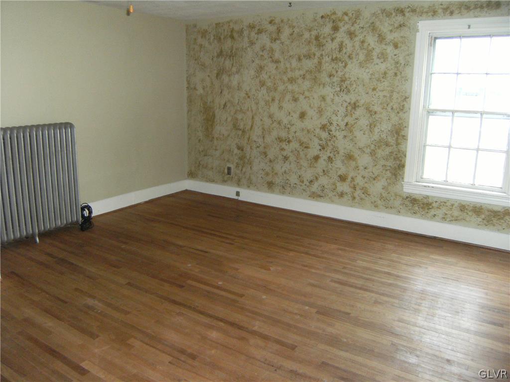 1115 Main Street Slatington, PA 18080 - Photo 18 of 19 an empty room with wooden floor and windows