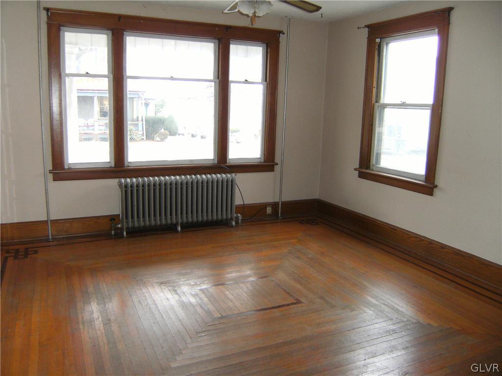 1115 Main Street Slatington, PA 18080 - Photo 5 of 19 an empty room with wooden floor and windows
