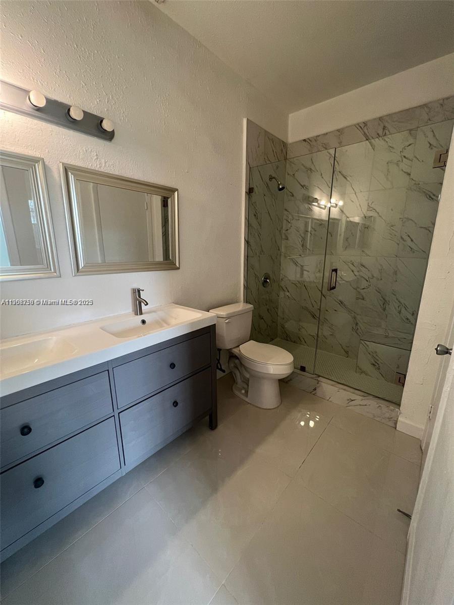 2001 Northwest 96th Terrace, Unit 10C Pembroke Pines, FL 33024 - Photo 8 of 10 a spacious bathroom with a double vanity sink mirror and toilet