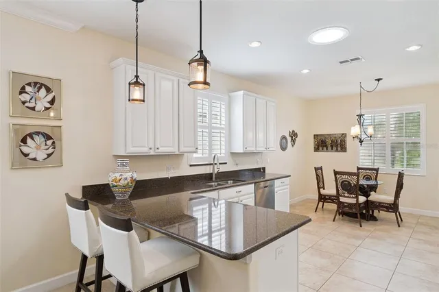 a kitchen with granite countertop cabinets and chairs