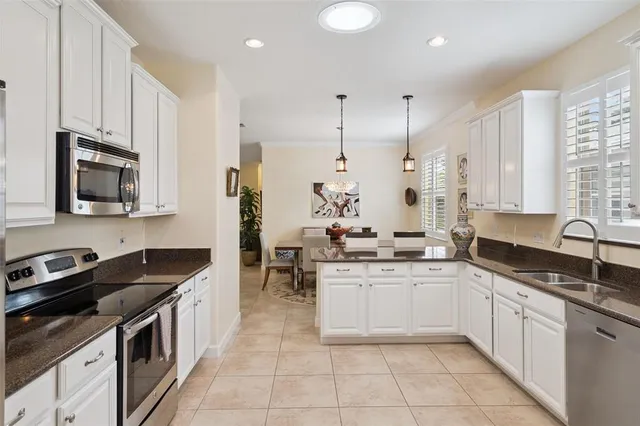 a kitchen with stainless steel appliances granite countertop a sink and cabinets