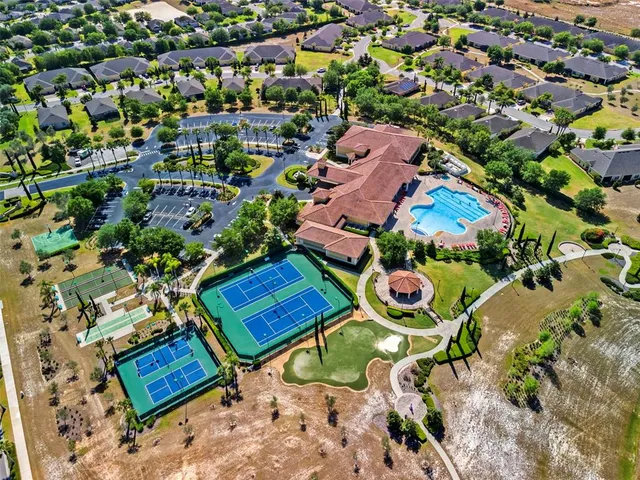 an aerial view of a house with a yard and lake view