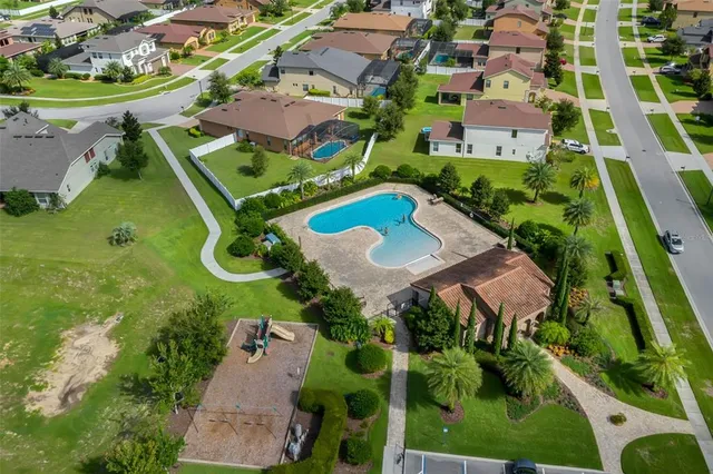 an aerial view of residential houses with outdoor space and street view