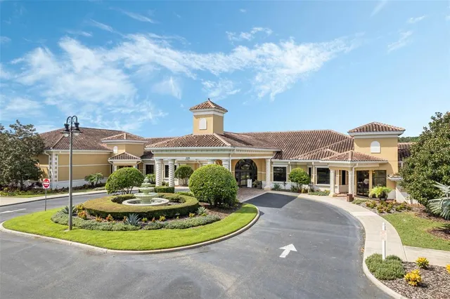 a view of a white house with a swimming pool and a yard