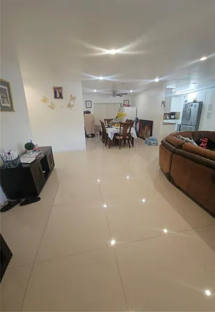 a living room with furniture and gym equipment