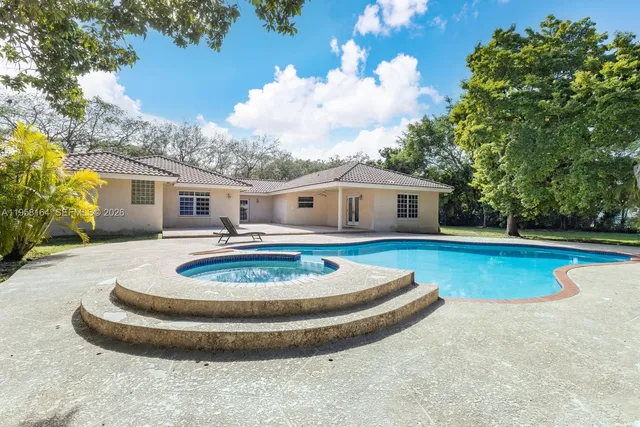 a spacious bedroom with a bed and a chandelier