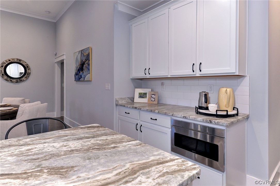 178 Old Course Loop Cape Charles, VA 23310 - Photo 11 of 49 a kitchen with granite countertop a sink cabinets and stainless steel appliances