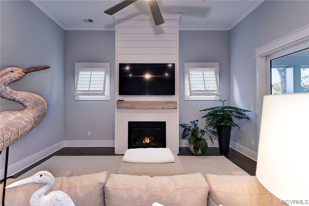 178 Old Course Loop Cape Charles, VA 23310 - Photo 16 of 49 a living room with furniture a fireplace and a flat screen tv