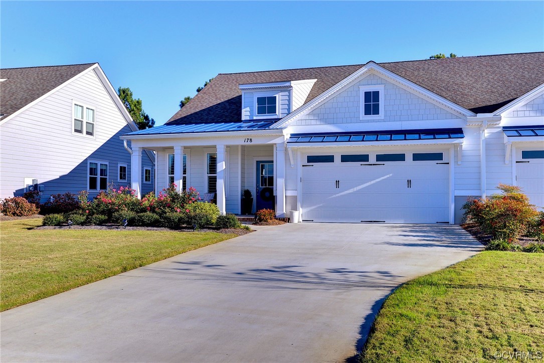 178 Old Course Loop Cape Charles, VA 23310 - Photo 2 of 49 a front view of a house with a yard and garage